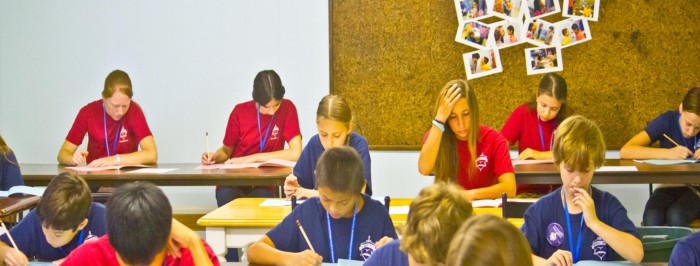 Uczniowie siedzcy przed biurkami w szkole